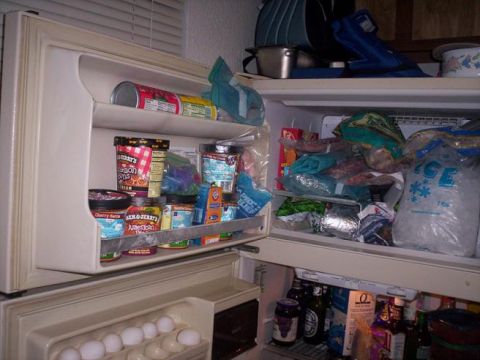 1989 Ford Bronco - Interior view of a refrigerator stocked with various food items and drinks.