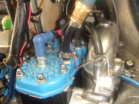 1995 Ford Mustang - Detail of an engine part, possibly from a watercraft or snowmobile, with various fittings and connections.
