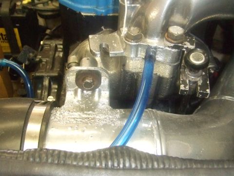 1995 Ford Mustang - A close-up view of an engine's intake manifold and associated plumbing, with a watermark for Supermotors.net visible.