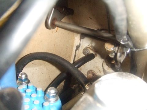 1995 Ford Mustang - Detail view of engine compartment parts, including hoses and metal brackets.