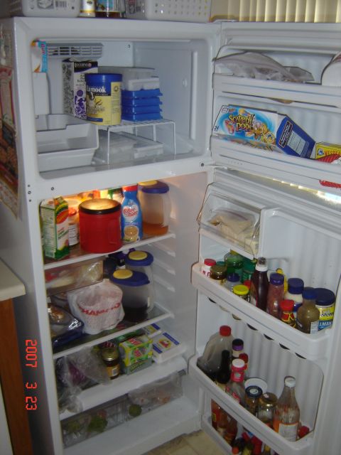1993 Ford Bronco - The interior of a refrigerator is filled with various food items and condiments.