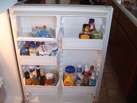 1988 Ford Bronco - A look inside a refrigerator filled with various condiments and dairy products.
