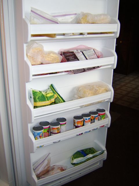 1989 Ford Bronco - The interior of a refrigerator is shown, filled with various food items organized on shelves.