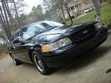 2001 Ford Crown Victoria - Black 2001 Ford Crown Victoria seen from a 3/4 front angle on a paved surface.