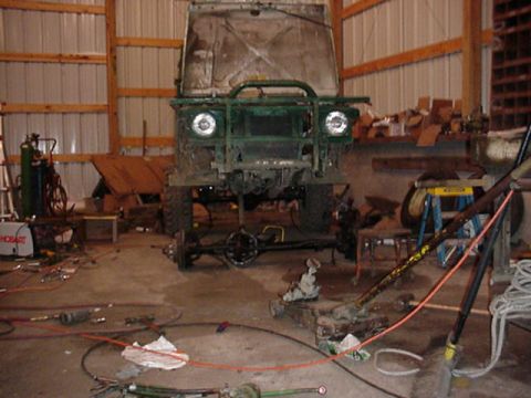 1992 Ford Bronco - This vehicle is in a garage, possibly being worked on. It is not a 1992 Ford Bronco.