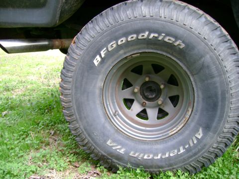 1989 Ford Bronco - Close-up of a BFGoodrich All-Terrain T/A tire and exhaust pipe.