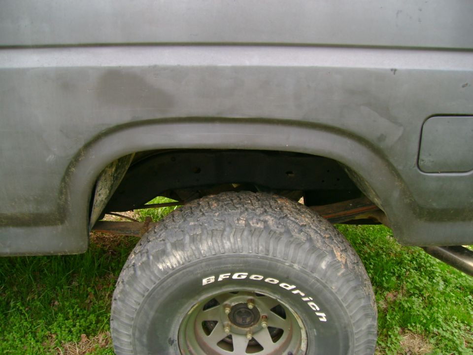 Rear wheel well and tire of a truck, showing BFGoodrich tire and part of the frame