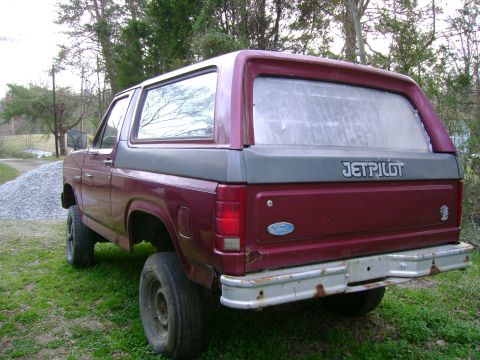 1989 Ford Bronco - Rear view of a maroon and grey 1989 Ford Bronco, a Jetpilot decal on the tailgate.