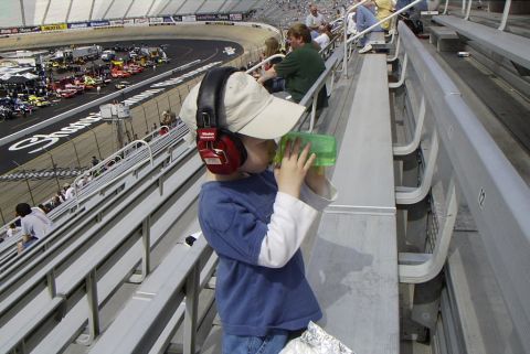 1995 Ford Bronco - A child enjoys the race day atmosphere from the stands, complete with noise-canceling headphones.