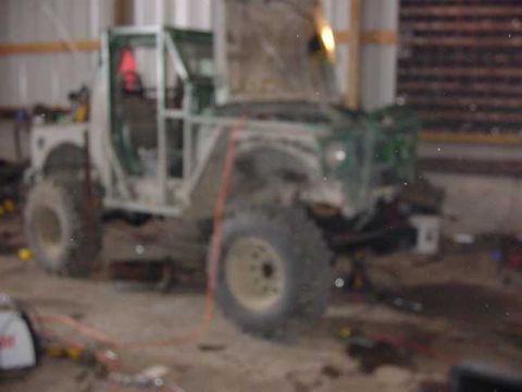 1992 Ford Bronco - This heavily modified off-road vehicle appears to be undergoing extensive customization in a workshop environment.
