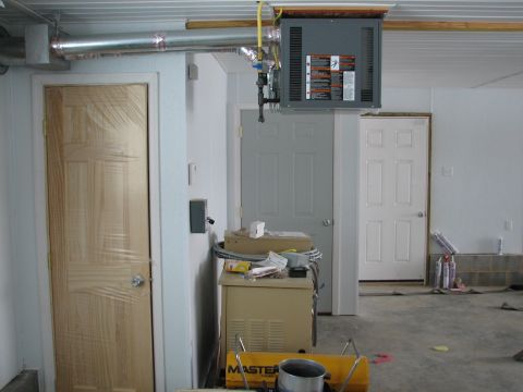 1992 Ford Bronco - Interior view of a garage space multiple doors, a hanging heater unit, and various stored items.