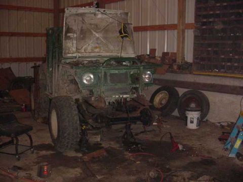 1992 Ford Bronco - This off-road vehicle, possibly undergoing a Dana 44 and YJ swap, is seen in a workshop with its hood open and front end elevated on jack s…