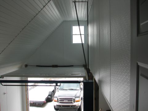 1992 Ford Bronco - A Ford F-Series truck and trailer are visible inside a garage with the door open.