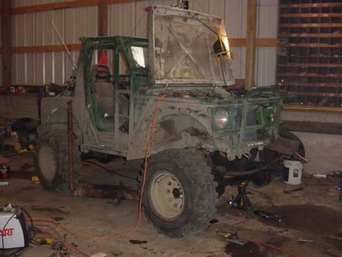 1992 Ford Bronco - This off-road vehicle appears to be undergoing significant modifications or repairs in a workshop setting.