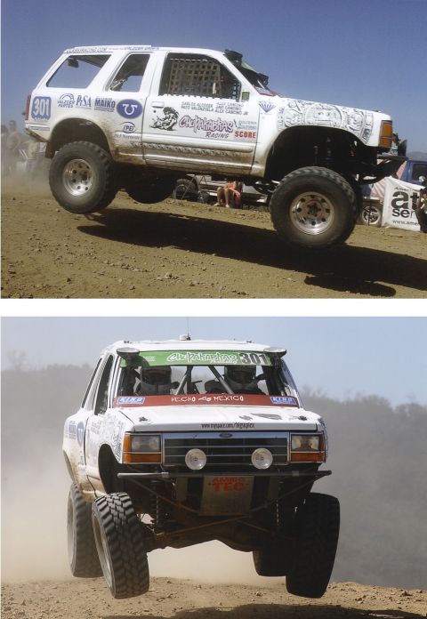 1992 Ford Explorer - This modified off-road truck is airborne during a race event, showing extensive modifications for competition.