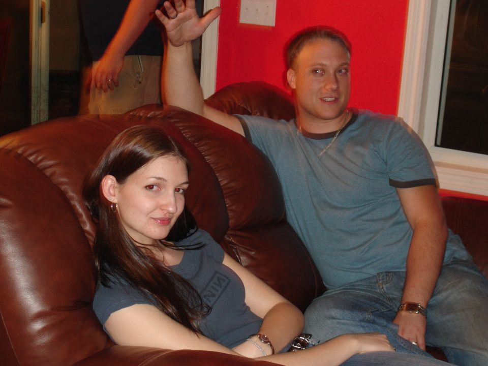 People relaxing on a brown leather couch