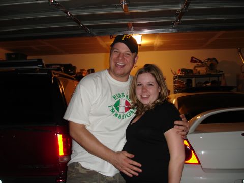 1994 Ford Probe - A couple poses for a photo in a garage, with two vehicles in the background.