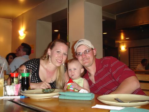 1994 Ford Probe - A family enjoys a meal together at a restaurant, with a baby seated between the parents.