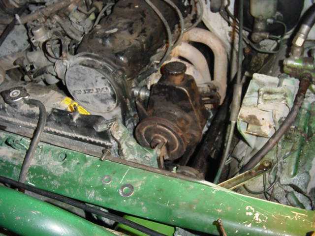 Engine bay with power steering pump and radiator cap