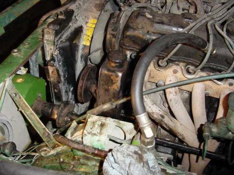 1992 Ford Bronco - Close-up view of the engine bay, focusing on the power steering pump and associated hoses.