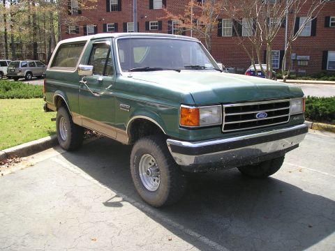 1989 Ford Bronco - This 1989 Ford Bronco features a two-tone paint scheme with tan lower body trim and a white removable top.