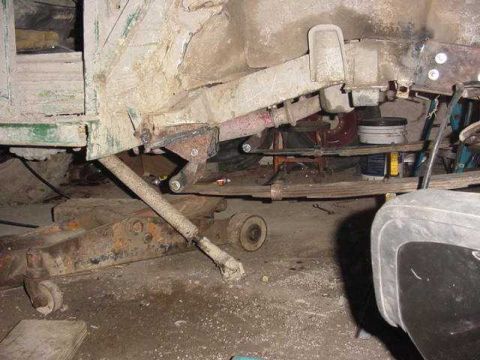 1992 Ford Bronco - Undercarriage view shows suspension components and frame structure, with some parts appearing rusty.