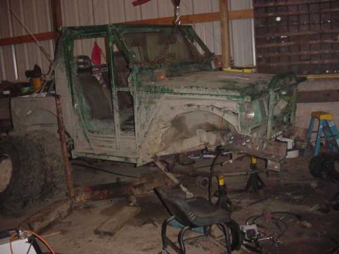 1992 Ford Bronco - This vehicle's chassis is undergoing modifications in a workshop setting.