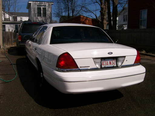 Rear view of a white 1999 Ford Crown Victoria with license plate 43A W32