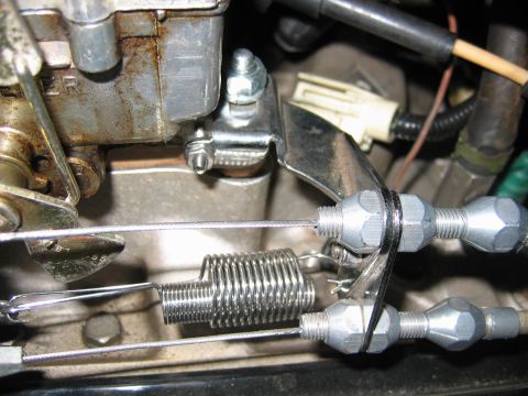 1985 Ford LTD Crown Victoria - Carburetor throttle linkage detail showing springs and adjustment nuts.