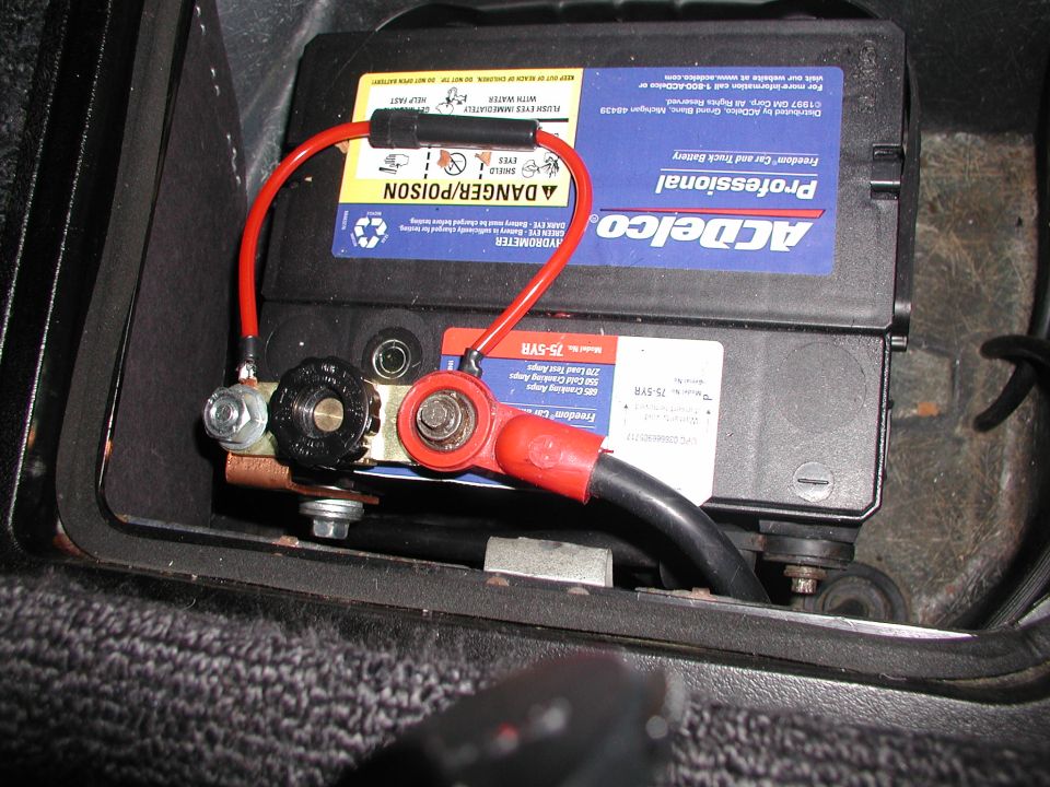 ACDelco battery installed in a vehicle with red positive and black negative cables