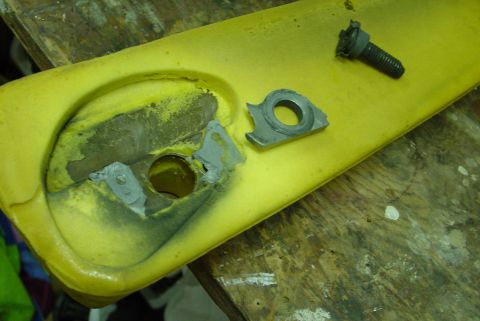1993 Ford Bronco - This image shows a disassembled interior component, likely an armrest, with its associated hardware.