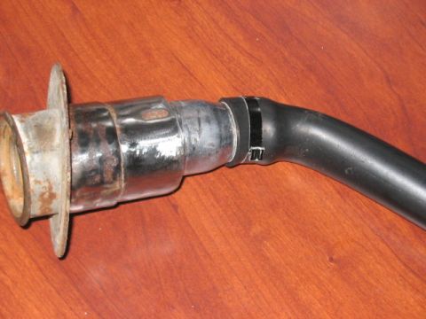 1991 Ford Bronco - A close-up view of a vehicle's fuel filler neck and hose assembly.