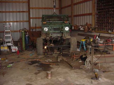 1992 Ford Bronco - This vehicle appears to be undergoing significant modifications or repairs in a workshop setting.