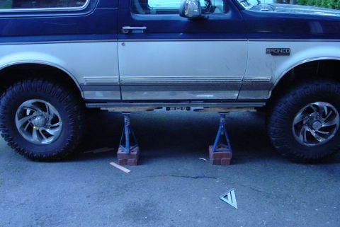 1993 Ford Bronco - This 1993 Ford Bronco is shown on jack stands, highlighting its side profile with a two-tone paint scheme.