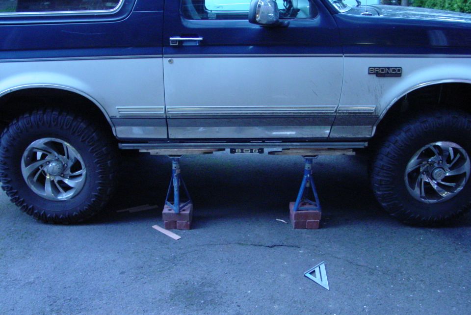 1993 Ford Bronco side view, two-tone blue and silver, on jack stands