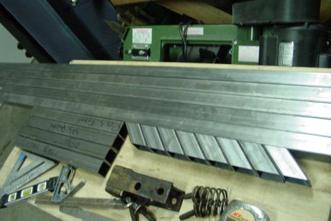 1993 Ford Bronco - Metal tubing and shop tools are laid out on a workbench, ready for a project.