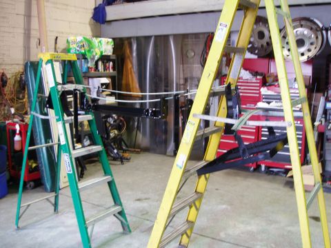 1979 Ford Bronco - A workshop scene with ladders and automotive parts, not a 1979 Ford Bronco.