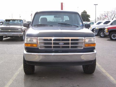1995 Ford Bronco - This 1995 Ford Bronco is shown from the front, with a chrome grille and headlights visible.