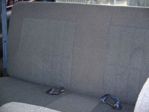 1995 Ford Bronco - The rear seat of the vehicle is shown with a seatbelt buckle visible on the right side.