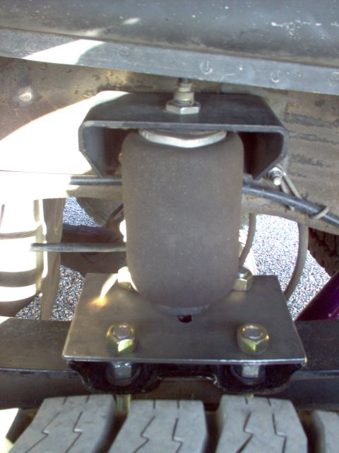 1995 Ford Bronco - This image shows an air suspension component, likely an air spring bellows, mounted to a vehicle's chassis.