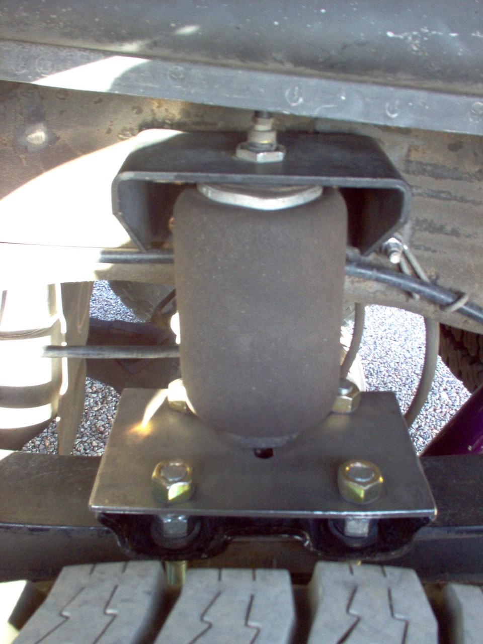 Close-up of an air suspension bellows and mounting hardware