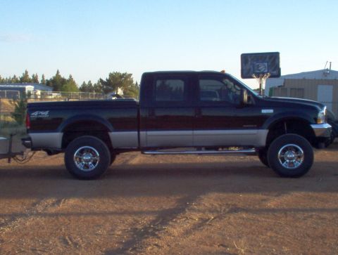 1995 Ford Bronco - This pickup truck features a two-tone paint scheme and a 4x4 badge on the fender.