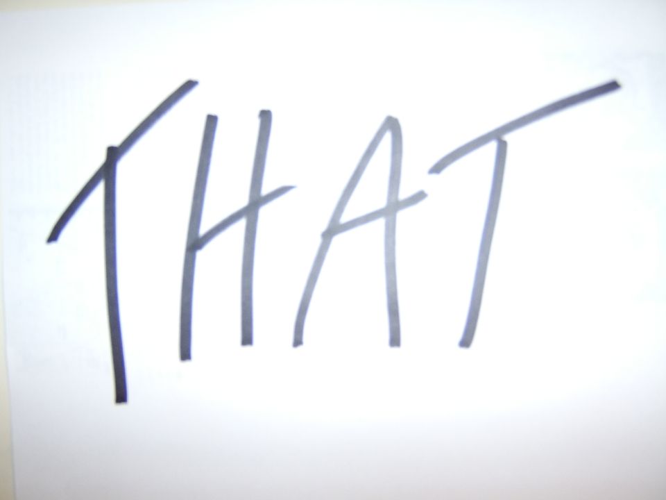 handwritten word THAT on white paper