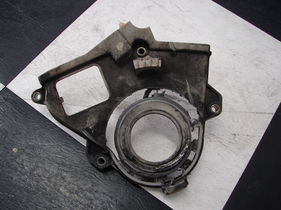 Gray metal crank pulley cover with circular opening and mounting holes