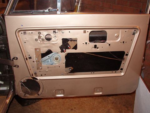 1975 Ford Bronco - This door's speaker hole was butchered even worse, and it's not in the same position, so I have to clean it up a little & widen it upward.…