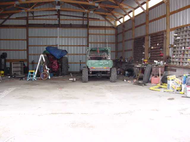 Green off-road vehicle rear view in garage