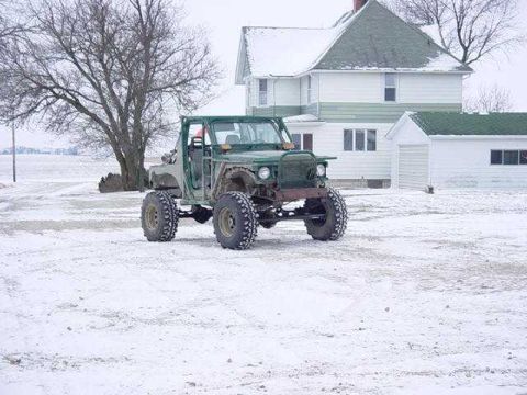 1992 Ford Bronco - This heavily modified vehicle, likely a custom build, sits in a snow-covered landscape.