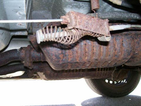 1999 Ford Crown Victoria - Close-up view of the undercarriage, focusing on exhaust system and suspension parts.
