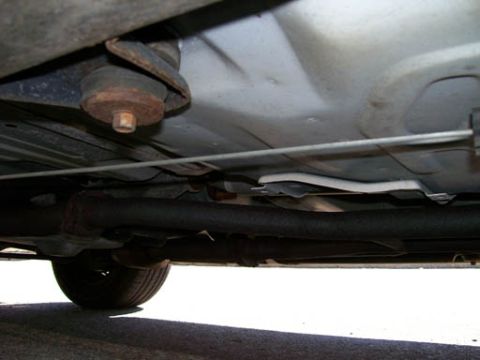 1999 Ford Crown Victoria - Underbody view of a 1999 Ford Crown Victoria, showing suspension and exhaust system components.