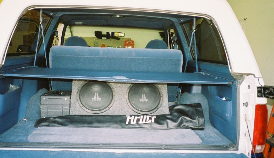 1996 Ford Bronco interior cargo area with dual JL Audio subwoofers and a Hi-Fidelity cover
